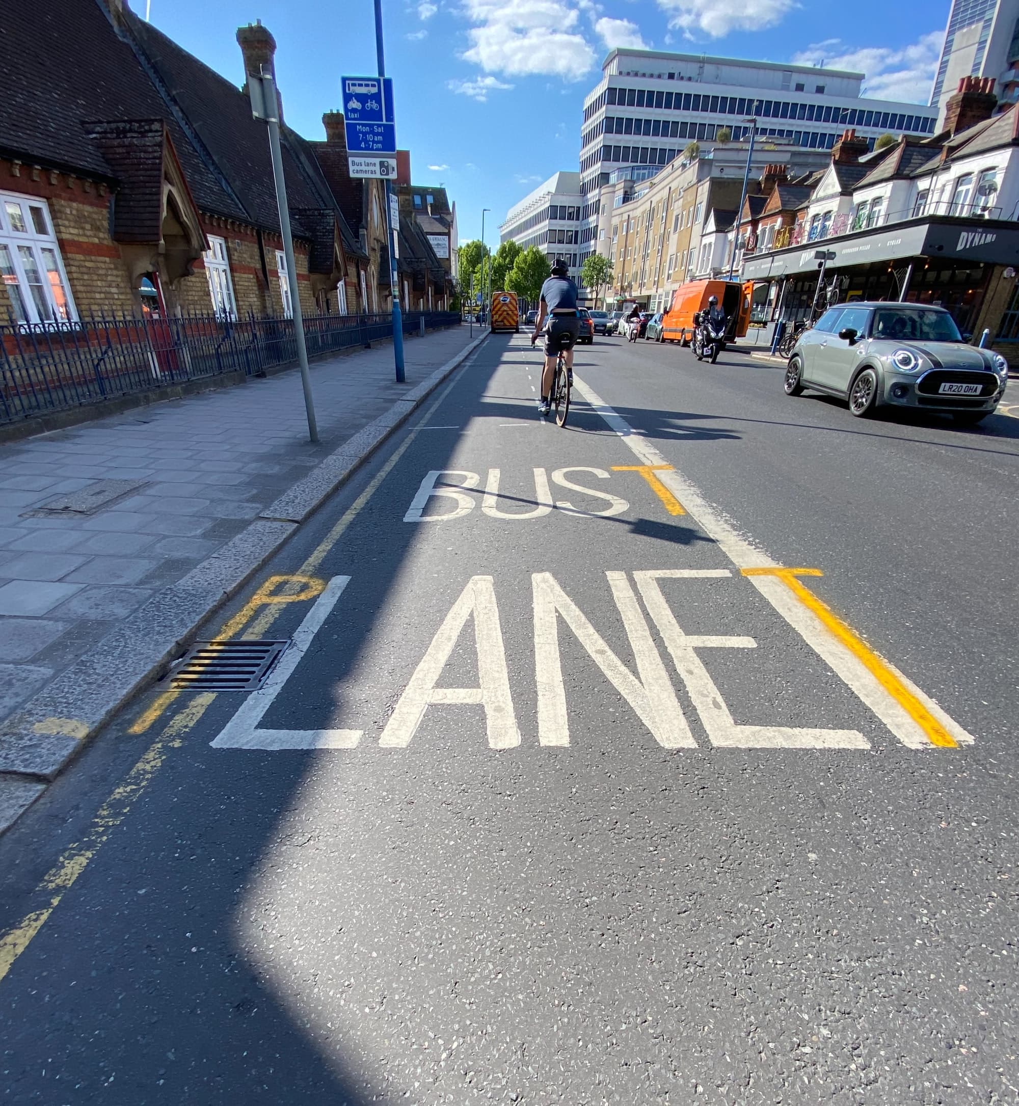 A bus lane in Putney is repurposed to express concern over covid or possibly the environment. 